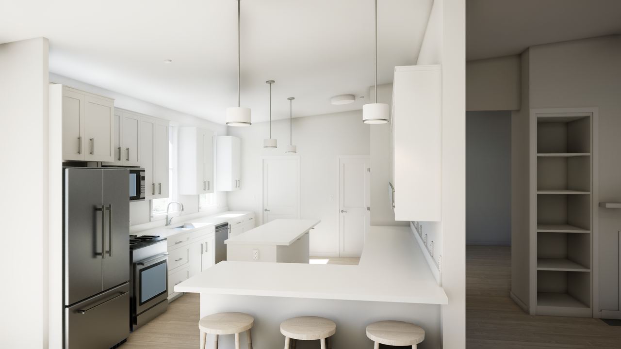 White kitchen peninsula with stools, pendant lights and pale cabinetry behind it.