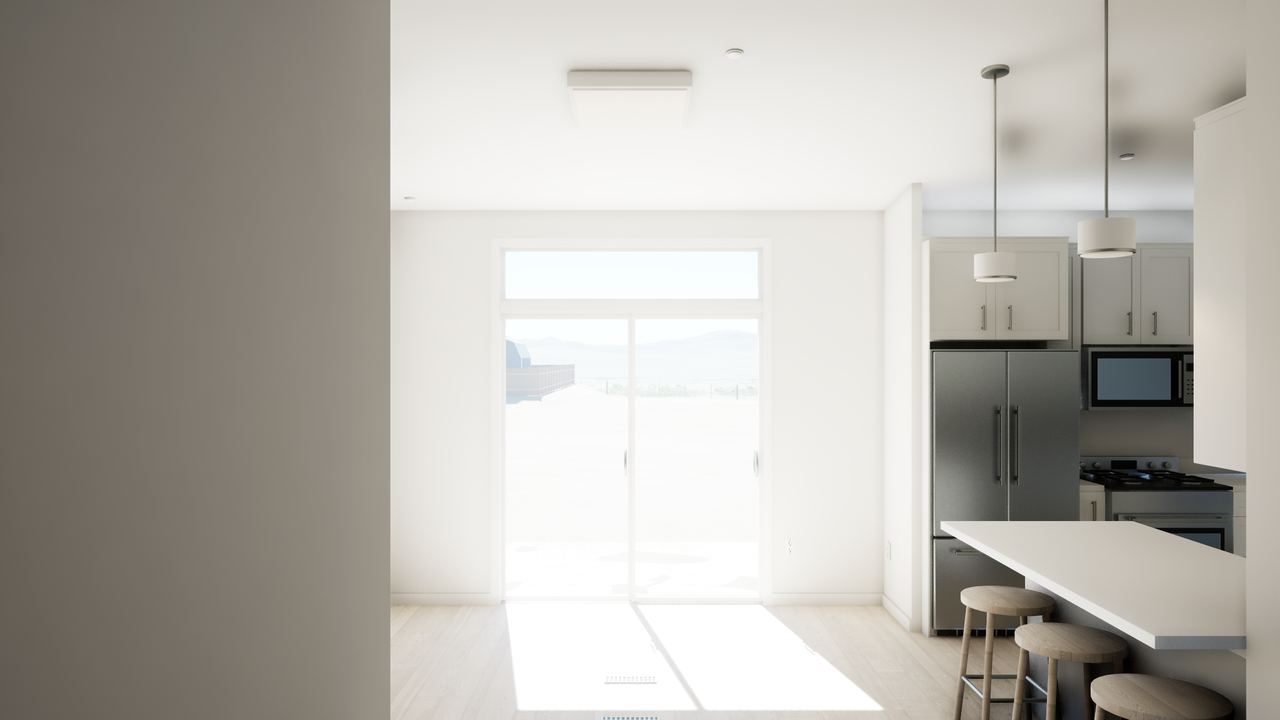 Dining area facing glazed patio doors, with the kitchen peninsula along the right.